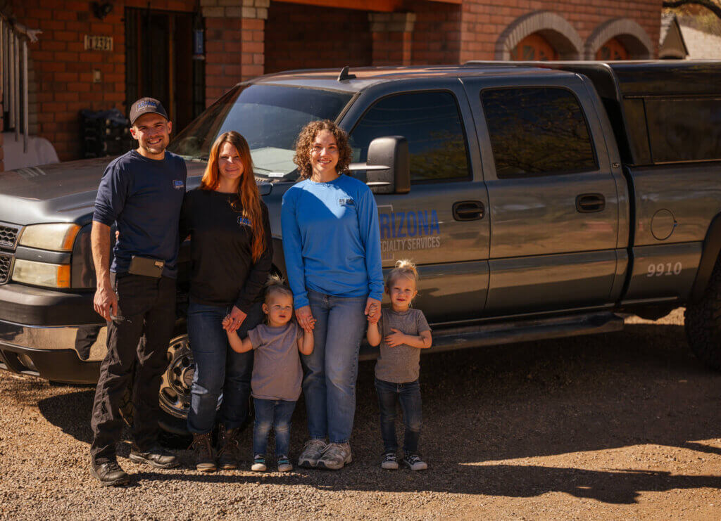 A team of bed bug treatment experts standing in front of a grey truck